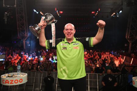Michael van Gerwen lifts the 2022 Players Championship Finals trophy.