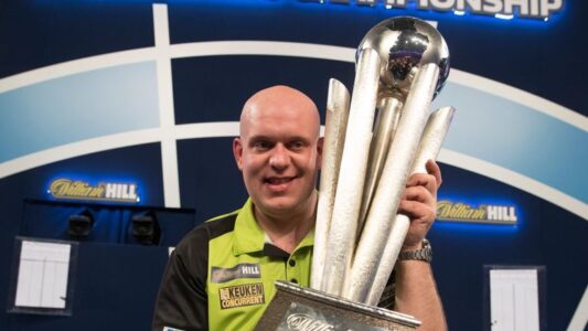 Michael van Gerwen holding the Sid Waddell Trophy, awarded to the winner of PDC World Darts Championship.
