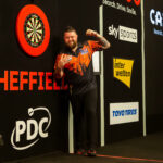 Michael Smith celebrates winning a Premier League Darts night.
