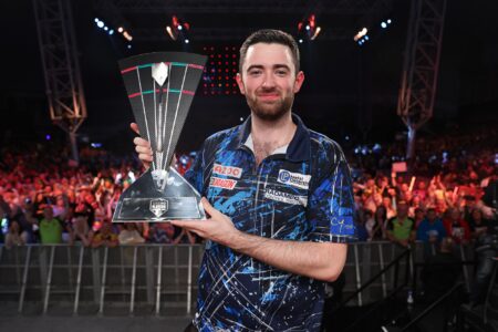 Luke Humphries holding the 2023 Players Championship Finals trophy.