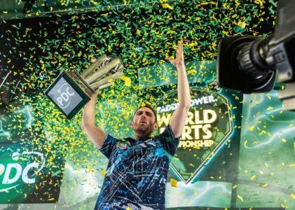 Luke Humphries celebrates with the Paddy Power World Darts Championship trophy.