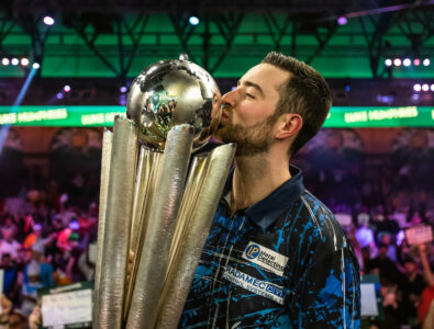Luke Humphries kisses the Paddy Power World Darts Championship trophy.