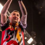 Nathan Aspinall on stage at the 2024 Premier League Darts.