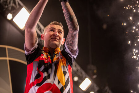 Nathan Aspinall on stage at the 2024 Premier League Darts.