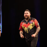 Michael Smith on stage at the 2024 Premier League Darts