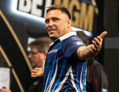Gerwyn Price playing on stage at the 2024 Premier League Darts.