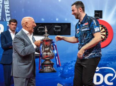 Luke Humphries receives the Betfred World Matchplay trophy.