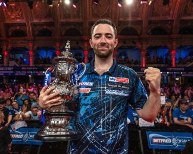 Luke Humphries celebrating with the Betfred World Matchplay trophy.