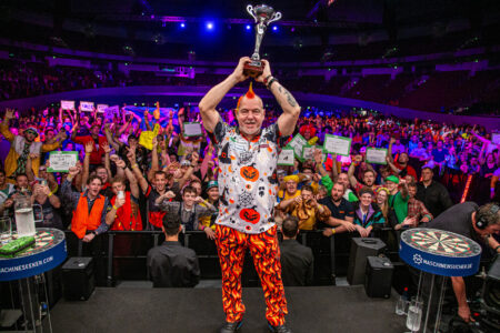 Peter Wright lifts the European Championship Darts trophy.