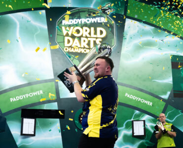 Luke Littler holding the Paddy Power World Darts Championship trophy. Credit: PDC
