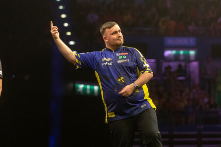 Luke Littler playing on stage in the 2025 Premier League Darts