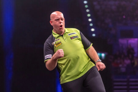 Michael van Gerwen playing on stage in the 2025 Premier League Darts