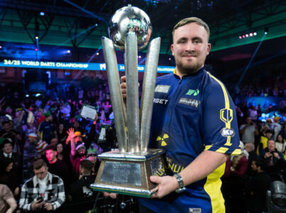 Luke Littler holding the Sid Waddell Trophy, awarded to the winner of the World Darts Championship.