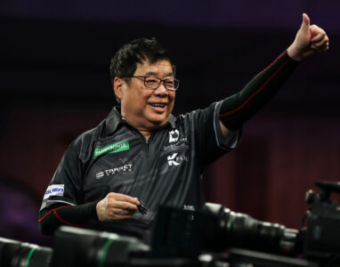 Paul Lim celebrating on stage at the Paddy Power World Darts Championship.